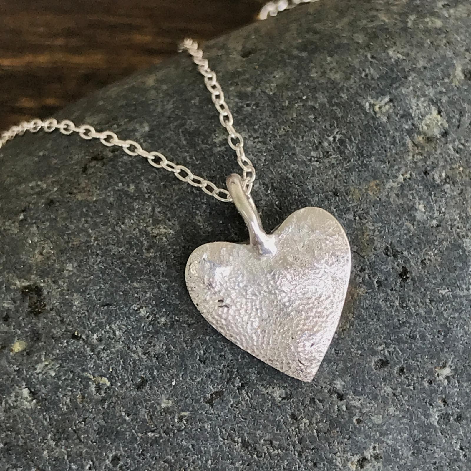 Silver heart-shaped paw print pendant