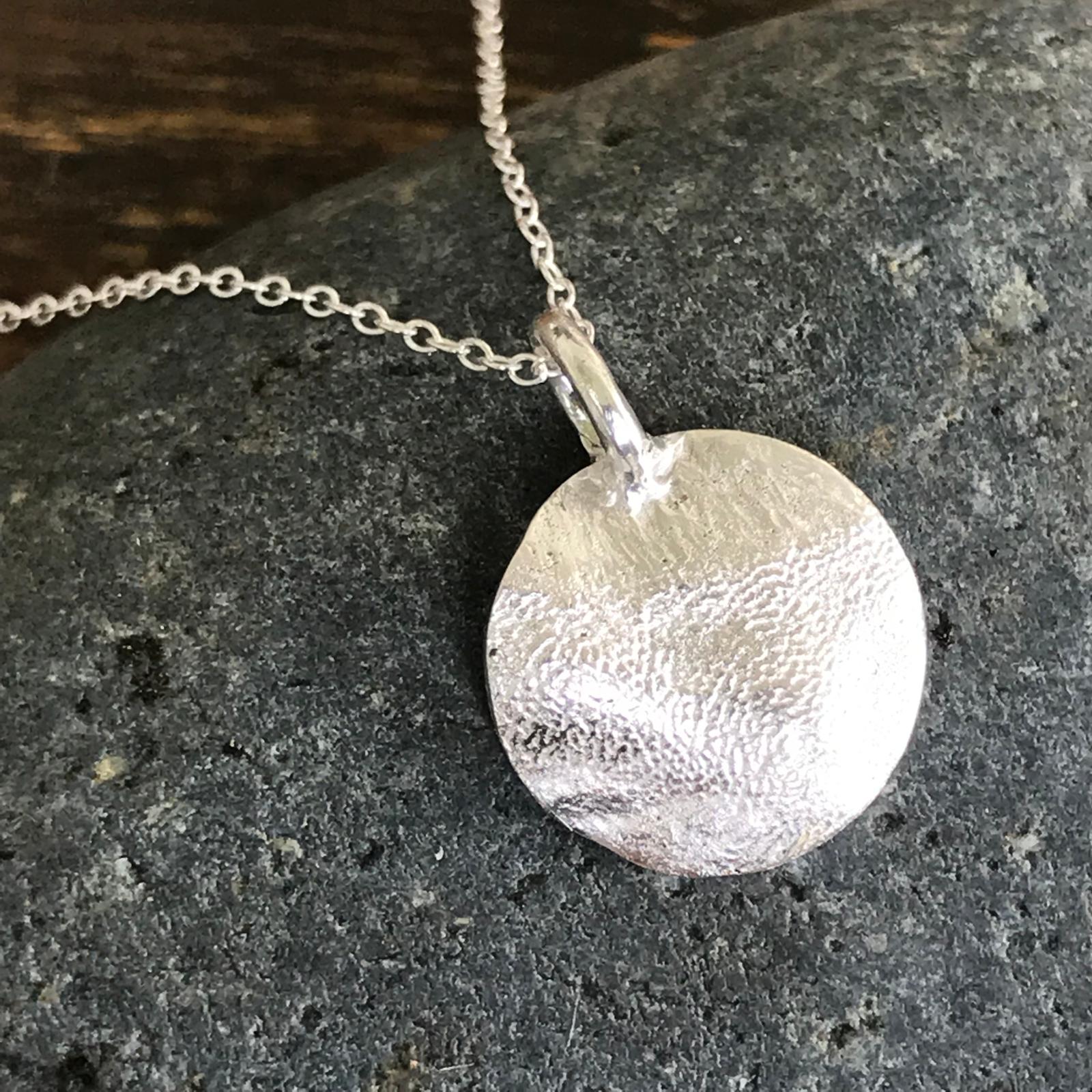 Silver paw print pendant keepsake handcrafted in Singapore