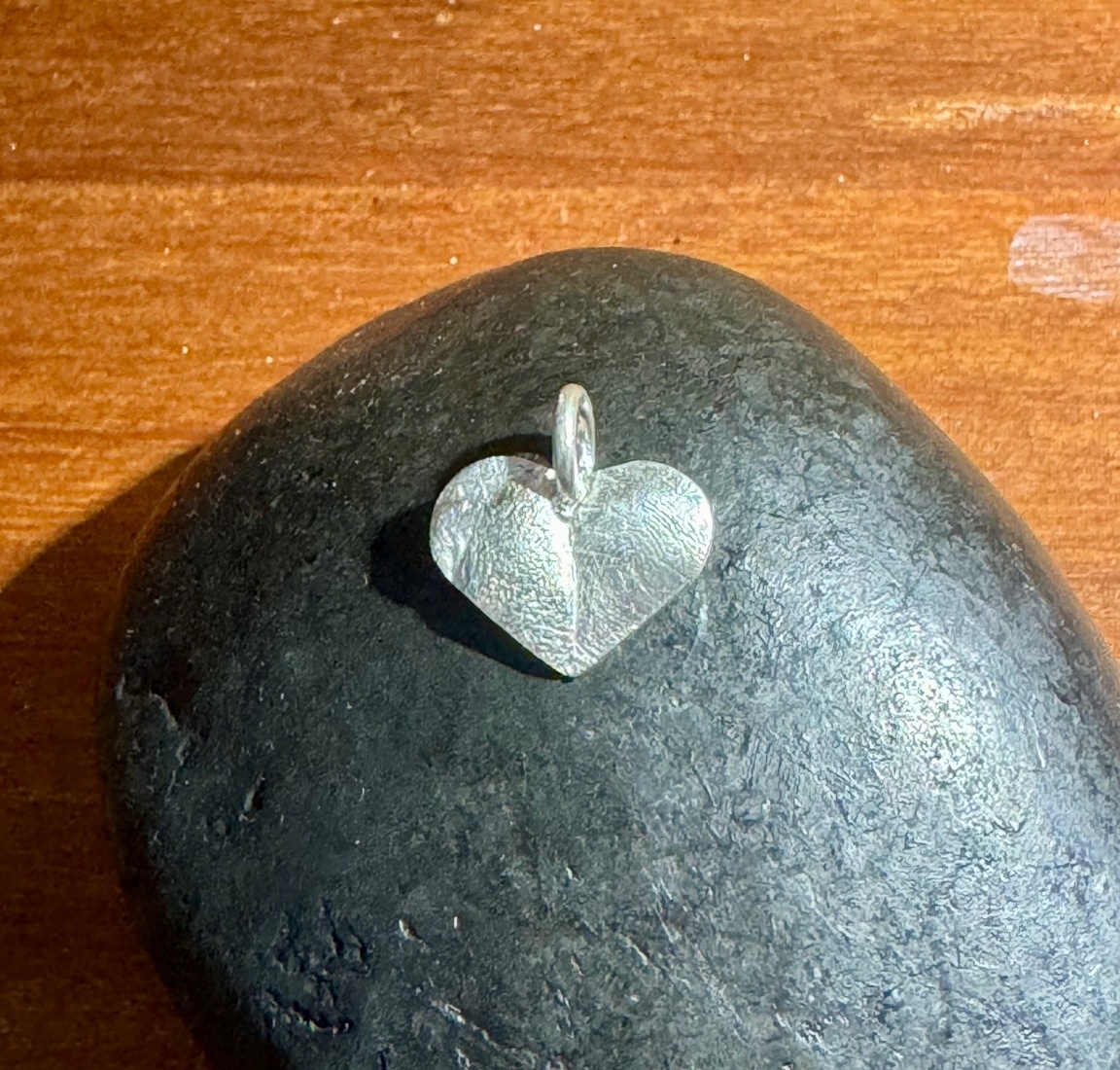 Silver nose-print pendant worn close to the heart